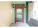 Close-up of front door with vintage sconces and brick detailing at 989 Woodruff Pl E Dr, Indianapolis, IN 46201