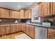Bright kitchen features wood cabinets, stainless steel appliances, and stone countertops at 989 Woodruff Pl E Dr, Indianapolis, IN 46201