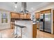 Updated kitchen featuring a stainless-steel refrigerator and adjacent breakfast bar at 989 Woodruff Pl E Dr, Indianapolis, IN 46201