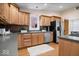 Updated kitchen featuring wood cabinets, stainless steel appliances, and stone countertops at 989 Woodruff Pl E Dr, Indianapolis, IN 46201