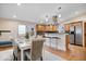 Eat-in kitchen with stainless steel appliances, island, and hardwood floors at 989 Woodruff Pl E Dr, Indianapolis, IN 46201