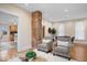 Bright living room with hardwood floors, exposed brick, and open floor plan at 989 Woodruff Pl E Dr, Indianapolis, IN 46201