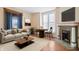 Bright living room featuring a decorative fireplace, hardwood floors, and ample natural light at 989 Woodruff Pl E Dr, Indianapolis, IN 46201