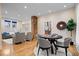 Open-concept living space with hardwood floors and a decorative brick pillar at 989 Woodruff Pl E Dr, Indianapolis, IN 46201