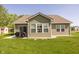 Back of home featuring sliding glass doors to the patio and green lawn at 1021 Boots Trl, Greenfield, IN 46140