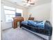 Bright bedroom features a rolltop desk, ceiling fan, and comfortable bed with stylish blanket at 1021 Boots Trl, Greenfield, IN 46140