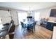 Inviting dining area features a round table, stylish bar cart, and sliding glass doors for natural light at 1021 Boots Trl, Greenfield, IN 46140