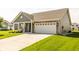 This lovely home features a brick and siding exterior and an attached two-car garage at 1021 Boots Trl, Greenfield, IN 46140