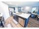 A modern kitchen features an island with seating, stainless steel appliances, and wood floors throughout at 1021 Boots Trl, Greenfield, IN 46140