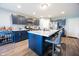 Modern kitchen boasts dark cabinets, stainless appliances, central island seating, and light wood flooring at 1021 Boots Trl, Greenfield, IN 46140