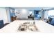 A kitchen is equipped with a large marble top island with seating, stainless steel appliances, and dark blue cabinets at 1021 Boots Trl, Greenfield, IN 46140