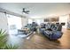 Spacious living room with a large leather sofa, wood floors, and access to the dining area through sliding barn doors at 1021 Boots Trl, Greenfield, IN 46140