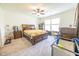 Comfortable primary bedroom boasts ample natural light, ceiling fan, and stylish furnishings at 1021 Boots Trl, Greenfield, IN 46140