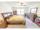 Spacious main bedroom featuring a ceiling fan, large windows, and a comfortable queen-size bed at 1021 Boots Trl, Greenfield, IN 46140