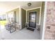 Cozy front porch with seating area and storm door at 1021 Boots Trl, Greenfield, IN 46140