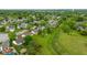 Aerial view of a residential neighborhood with green space, pond, and well-maintained homes at 1084 Lake W Dr, Brownsburg, IN 46112