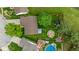 Aerial view of home and yard, featuring an in-ground pool, firepit, patio, and trampoline at 1084 Lake W Dr, Brownsburg, IN 46112