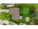 Aerial view of a home with a spacious backyard featuring a fire pit, trampoline, and lush greenery at 1084 Lake W Dr, Brownsburg, IN 46112