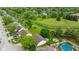 Aerial view of a property showcasing the backyard, including a pool, fire pit and play set at 1084 Lake W Dr, Brownsburg, IN 46112
