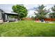 Landscaped backyard with a covered patio, play area, and fire pit for Gathering fun at 1084 Lake W Dr, Brownsburg, IN 46112