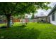Backyard featuring a tree, swing, firepit and patio with comfortable seating at 1084 Lake W Dr, Brownsburg, IN 46112