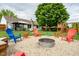 Backyard featuring a fire pit area and colorful Adirondack chairs for outdoor entertaining at 1084 Lake W Dr, Brownsburg, IN 46112