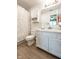Well-lit bathroom with white cabinets, laminate flooring, and neutral color at 1084 Lake W Dr, Brownsburg, IN 46112