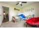 A brightly lit bedroom with a view of an outdoor scene, featuring a sitting area and carpet at 1084 Lake W Dr, Brownsburg, IN 46112