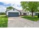 Well-maintained home with a spacious driveway leading to an attached garage at 1084 Lake W Dr, Brownsburg, IN 46112
