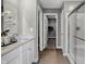 Bright bathroom featuring dual sinks, a glass-enclosed shower, and a walk-in closet at 1136 Tansley Ln, Avon, IN 46123