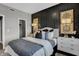 Tastefully designed main bedroom boasts a sleek black accent wall and an upholstered headboard at 1136 Tansley Ln, Avon, IN 46123