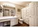 Bright bathroom featuring a large mirror, vanity, and a shower-tub combination with a patterned curtain at 11646 Winding Wood Dr, Indianapolis, IN 46235
