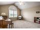 Well-lit bedroom showcasing a vaulted ceiling, large arched window, and a cozy reading nook at 11646 Winding Wood Dr, Indianapolis, IN 46235