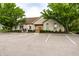 Community clubhouse with ample parking, attractive landscaping, and welcoming facade at 11646 Winding Wood Dr, Indianapolis, IN 46235
