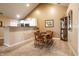Cozy dining area with table and chairs, next to the kitchen with white cabinets at 11646 Winding Wood Dr, Indianapolis, IN 46235
