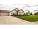Charming brick home with well-manicured lawn, attached garage, and large windows at 11646 Winding Wood Dr, Indianapolis, IN 46235
