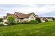 Beautifully landscaped single-story home with lush green lawn, mature trees, and well-maintained exterior at 11646 Winding Wood Dr, Indianapolis, IN 46235