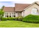 Attractive brick home featuring an arched window and complemented by lush green landscaping at 11646 Winding Wood Dr, Indianapolis, IN 46235