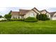 Well-maintained home with manicured lawn, mature landscaping, and inviting facade at 11646 Winding Wood Dr, Indianapolis, IN 46235