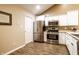 Well-lit kitchen features stainless steel appliances, gas range, and ample storage space in white cabinets at 11646 Winding Wood Dr, Indianapolis, IN 46235