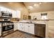 Stylish kitchen with stainless steel appliances, white cabinetry, and spacious countertops for meal preparation at 11646 Winding Wood Dr, Indianapolis, IN 46235