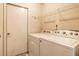 Laundry room is equipped with a washer and dryer for convenient laundry care at 11646 Winding Wood Dr, Indianapolis, IN 46235