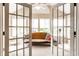 Bright sunroom with French doors offers a relaxing space to enjoy natural light and outdoor views at 11646 Winding Wood Dr, Indianapolis, IN 46235