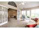 Open sunroom with ample space and natural light, perfect for relaxing and leads into the living area at 11646 Winding Wood Dr, Indianapolis, IN 46235