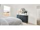 Cozy bedroom features a white bed, dark dresser, and a view to a window at 11904 Vale St, Indianapolis, IN 46235