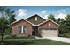 Charming brick home with a manicured lawn, an attached two-car garage, and manicured landscaping at 11904 Vale St, Indianapolis, IN 46235