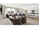 Open-concept living area with comfortable seating, island with barstools, and modern kitchen appliances at 11904 Vale St, Indianapolis, IN 46235