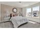 Comfortable bedroom with buffalo-check wallpaper and lots of light from the large windows at 11916 Vale St, Indianapolis, IN 46235