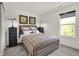 Charming bedroom with a plaid comforter, decorative pillows, and window with natural light at 11916 Vale St, Indianapolis, IN 46235