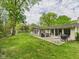 Expansive backyard with patio, outdoor grill, and seating, perfect for entertaining and enjoying the outdoors at 12 Windridge St, Country Club Heights, IN 46011